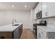 Beautiful kitchen with an island, stainless appliances, and white marble backsplash at 58 Black Gum Ln # 47, Auburn, GA 30011