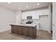 Modern kitchen features a stylish island, white cabinets, and stainless steel appliances at 58 Black Gum Ln # 47, Auburn, GA 30011