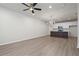 Spacious living room with light plank flooring and an open floor plan to the kitchen at 58 Black Gum Ln # 47, Auburn, GA 30011