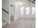 Bright living room offers stairs, plank floors, and a view of the restroom at 58 Black Gum Ln # 47, Auburn, GA 30011