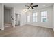 Bright living room with stairs, plank floors, and a door to the outside at 58 Black Gum Ln # 47, Auburn, GA 30011