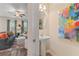 Stylish half bathroom adjacent to a living area; artwork and sleek pedestal sink at 312 Navigator Ln, Mcdonough, GA 30253