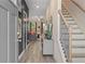 Inviting foyer with hardwood floors, staircase, and view into the open-concept living space at 312 Navigator Ln, Mcdonough, GA 30253