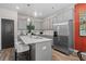 Well-lit kitchen with stainless steel appliances, gray cabinets, a kitchen island with bar stool seating at 312 Navigator Ln, Mcdonough, GA 30253