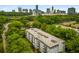 Aerial view of a well-maintained apartment building surrounded by trees with a city skyline in the background at 3203 Lenox Ne Rd # 3, Atlanta, GA 30324