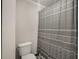 Neutral bathroom featuring a toilet and decorative gray shower curtain at 3203 Lenox Ne Rd # 3, Atlanta, GA 30324