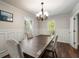 Comfortable dining area with a wooden table, neutral chairs, and modern chandelier at 3203 Lenox Ne Rd # 3, Atlanta, GA 30324