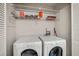 Bright laundry room with modern washer and dryer and overhead wire rack shelving at 3203 Lenox Ne Rd # 3, Atlanta, GA 30324
