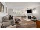Spacious living room with hardwood floors, a fireplace, neutral-toned furniture, and large shuttered windows at 3203 Lenox Ne Rd # 3, Atlanta, GA 30324