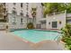 Inviting outdoor pool surrounded by a deck, palm trees, and building architecture at 3203 Lenox Ne Rd # 3, Atlanta, GA 30324