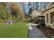 Spacious backyard with outdoor kitchen, fireplace, and stone patio at 3540 Tuxedo Nw Rd, Atlanta, GA 30305