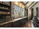 Wet bar area with custom cabinets, granite countertops, shelving, and window view at 3540 Tuxedo Nw Rd, Atlanta, GA 30305