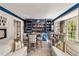 Stylish home bar featuring custom blue cabinetry, two tables with seating, and a cozy sofa area at 3540 Tuxedo Nw Rd, Atlanta, GA 30305
