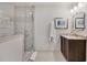 Bright bathroom with tile shower, marble countertop, and decorative mirror at 3540 Tuxedo Nw Rd, Atlanta, GA 30305