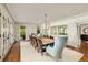 Spacious dining room features wallpapered walls, hardwood floors and seating for ten under decorative light fixtures at 3540 Tuxedo Nw Rd, Atlanta, GA 30305