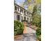 Inviting front entrance with a stone pathway, mature shrubs and an elegant exterior at 3540 Tuxedo Nw Rd, Atlanta, GA 30305