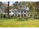 Classic two-story home with a lush green lawn and manicured landscaping at 3540 Tuxedo Nw Rd, Atlanta, GA 30305
