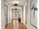Well-lit hallway featuring hardwood floors and chic decor with French doors and decorative art at 3540 Tuxedo Nw Rd, Atlanta, GA 30305