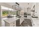 Bright kitchen featuring large island, custom cabinets, and an adjacent breakfast nook overlooking the backyard at 3540 Tuxedo Nw Rd, Atlanta, GA 30305