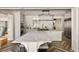 Open kitchen with large island and marble countertop, stainless steel appliances and an elegant light fixture at 3540 Tuxedo Nw Rd, Atlanta, GA 30305