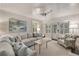 Inviting living room features wood walls, a cozy sectional sofa, bright windows, and comfortable seating at 3540 Tuxedo Nw Rd, Atlanta, GA 30305