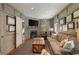 Cozy living room boasts a fireplace, wood-paneled walls, and an abundance of natural light from large windows at 3540 Tuxedo Nw Rd, Atlanta, GA 30305