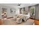 Elegant main bedroom with wood floors, neutral tones, ceiling fan, and ensuite access to a cozy living area at 3540 Tuxedo Nw Rd, Atlanta, GA 30305