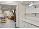 Versatile playroom or multi-purpose space adjacent to a sleek sink and cabinet area and expansive Gathering space at 3540 Tuxedo Nw Rd, Atlanta, GA 30305