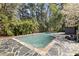 Private pool area surrounded by lush landscaping and stone patio at 3540 Tuxedo Nw Rd, Atlanta, GA 30305