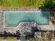 Aerial view of the sparkling pool surrounded by stone patio and trees at 3540 Tuxedo Nw Rd, Atlanta, GA 30305