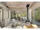 Bright sunroom features wood ceiling, fireplace, large windows overlooking the outdoor pool and greenery at 3540 Tuxedo Nw Rd, Atlanta, GA 30305