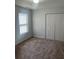 Cozy bedroom showcasing a ceiling fan, a window and closet at 8236 Eastshore Dr, Union City, GA 30291