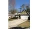 Charming home featuring a well-maintained lawn, complemented by a two-car garage and beautiful landscaping at 8236 Eastshore Dr, Union City, GA 30291