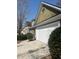 Close-up of the house's exterior, highlighting the two-car garage, trimmed lawn, and detailed siding at 8236 Eastshore Dr, Union City, GA 30291