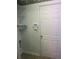 Mudroom with a white door, alarm system, wire shelving and view of the flooring at 8236 Eastshore Dr, Union City, GA 30291