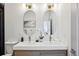 Modern bathroom with double sinks, stylish mirrors, and sleek fixtures at 1800 Charles Nw Pl, Atlanta, GA 30318