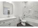 Clean bathroom featuring white marble-look tile, a modern vanity, and a tub with shower at 1800 Charles Nw Pl, Atlanta, GA 30318
