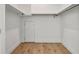 Walk-in closet with hardwood floors and minimal design, ready to be organized at 1800 Charles Nw Pl, Atlanta, GA 30318