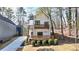 New construction modern home with a white facade, wood-accented balconies and a welcoming front porch at 1800 Charles Nw Pl, Atlanta, GA 30318