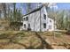 Modern white farmhouse exterior with large backyard, two-car garage, and professional landscaping at 1800 Charles Nw Pl, Atlanta, GA 30318