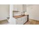 Bright kitchen features white cabinetry, stainless steel appliances, wood countertops, and modern fixtures at 1800 Charles Nw Pl, Atlanta, GA 30318