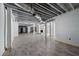 Large unfinished basement with wood-look flooring, exposed ceiling, and bright white walls, providing ample space for renovation at 3042 Peek Nw Rd, Atlanta, GA 30318