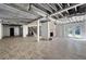Spacious unfinished basement with wood-look flooring, exposed ceiling, and brick fireplace, ready for customization and entertainment at 3042 Peek Nw Rd, Atlanta, GA 30318