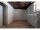Unfinished basement with a window, and concrete flooring covered for protection during construction at 3042 Peek Nw Rd, Atlanta, GA 30318