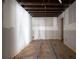 Unfinished basement with an exposed ceiling, and concrete flooring covered for protection during construction at 3042 Peek Nw Rd, Atlanta, GA 30318
