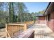 A beautiful wooden deck with railing that overlooks the tree filled back yard of the property at 3042 Peek Nw Rd, Atlanta, GA 30318