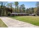 Sprawling single story home featuring a brick facade, mature trees and a long driveway at 3042 Peek Nw Rd, Atlanta, GA 30318