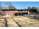 The backyard of the home showcases a brick exterior with a wooden deck and open garage space at 3042 Peek Nw Rd, Atlanta, GA 30318