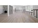 Open-concept living room featuring sleek new floors, neutral walls, and a modern fireplace at 3042 Peek Nw Rd, Atlanta, GA 30318