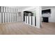 Open-concept living room featuring modern floors, black accent stripes on the wall and an eat-in kitchen at 3042 Peek Nw Rd, Atlanta, GA 30318